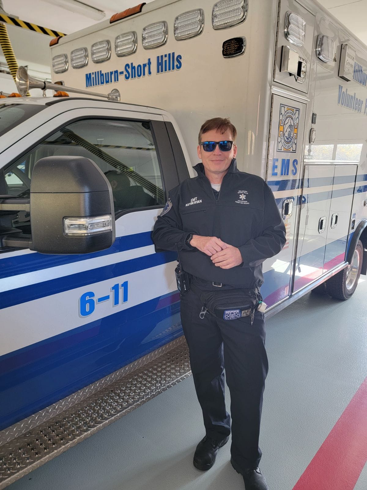 Kevin Ryan Standing in Front of Ambulance
